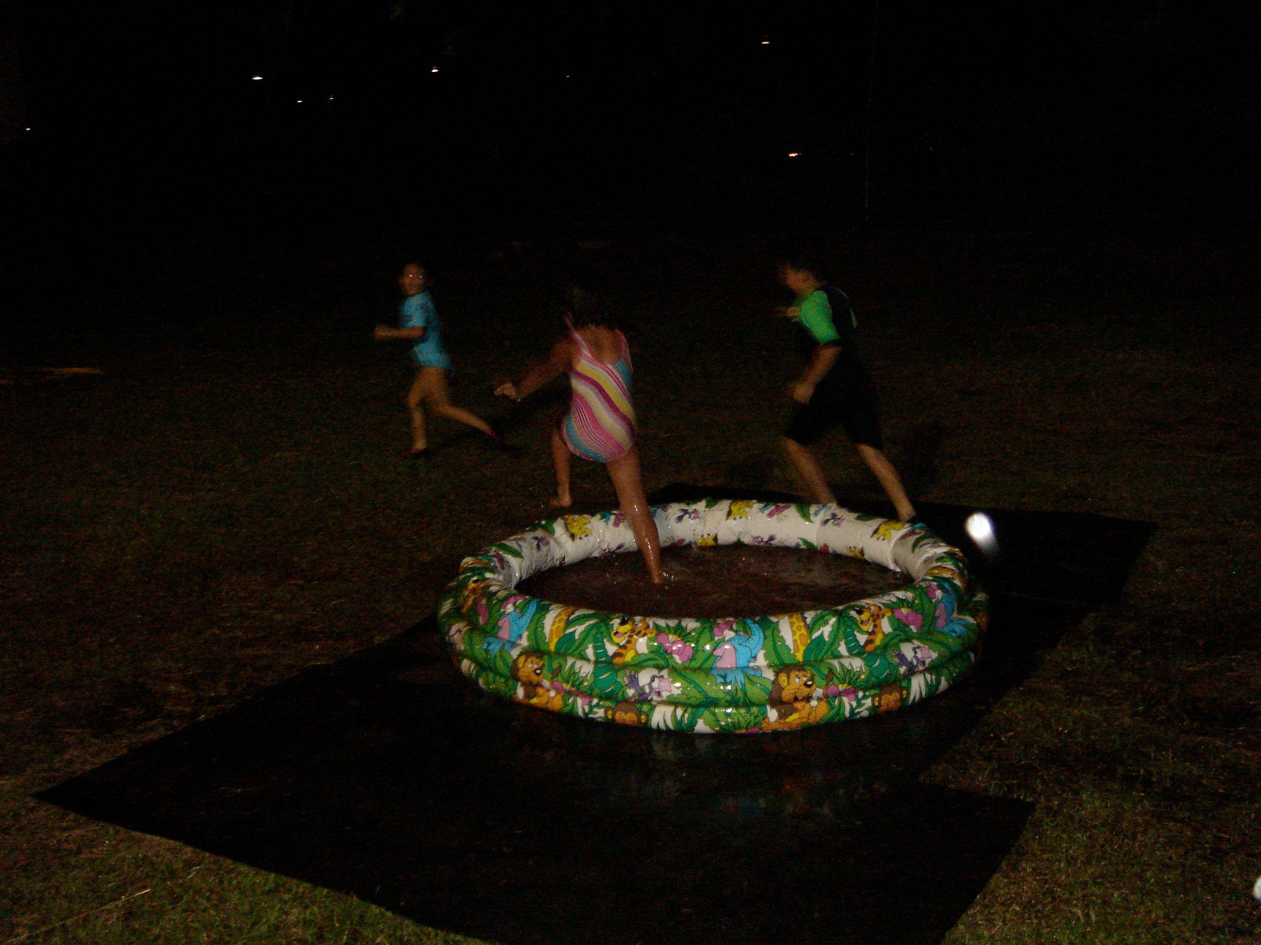 silhouettes running out of a kiddie pool